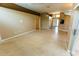 Open-concept living room showcasing tile floors, neutral paint, and easy access to other living spaces and outdoor areas at 1604 Boswell Ln, New Port Richey, FL 34655