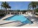 Resort-style community pool with lounge chairs, a pergola, and palm trees for relaxation and leisure at 1604 Boswell Ln, New Port Richey, FL 34655