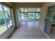 Sunroom featuring tile floors and lots of windows providing ample natural light, with access to the outside at 1604 Boswell Ln, New Port Richey, FL 34655