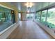 Bright sunroom with tile flooring, large windows, and natural light at 1604 Boswell Ln, New Port Richey, FL 34655
