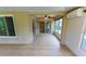 Enclosed sunroom with tile flooring, ceiling fan, and a window AC unit overlooking the backyard at 1604 Boswell Ln, New Port Richey, FL 34655