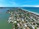 Gorgeous aerial view of beach homes with ocean and bay access for boating and recreation at 16301 Redington Dr, Redington Beach, FL 33708