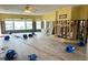 Large open room with damaged walls and new flooring at 16301 Redington Dr, Redington Beach, FL 33708