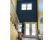 Bright, two-story foyer with a white staircase and a large transom window at 16301 Redington Dr, Redington Beach, FL 33708