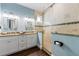 Elegant bathroom featuring double sinks, granite countertops, and a spacious glass-enclosed shower at 206 Church Ave, Bradenton Beach, FL 34217