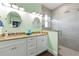 Bright bathroom with dual sinks, granite counters, and glass shower, exuding spa-like tranquility at 206 Church Ave, Bradenton Beach, FL 34217