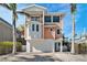 Charming coastal home with balcony, garage, and well-manicured landscaping under a bright blue sky at 206 Church Ave, Bradenton Beach, FL 34217