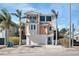 Inviting two-story home with a spacious garage, balcony, and lush landscaping at 206 Church Ave, Bradenton Beach, FL 34217