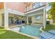Backyard with beautiful pool, hot tub, outdoor kitchen and TV for entertaining at 206 Church Ave, Bradenton Beach, FL 34217