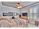 Charming bedroom with a wood-paneled ceiling, fan, and natural light at 214 Bon Vie Pl, Valrico, FL 33594