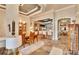 Elegant dining area adjacent to an open kitchen featuring a decorative ceiling and tile flooring at 214 Bon Vie Pl, Valrico, FL 33594