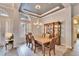 Formal dining room features tray ceiling, chandelier, and stylish furnishings at 214 Bon Vie Pl, Valrico, FL 33594