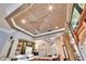 Open kitchen with an intricate wood ceiling design and a view of the dining area and front windows at 214 Bon Vie Pl, Valrico, FL 33594