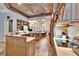 Open kitchen with stainless steel appliances, adjacent dining area, and unique wood ceiling design at 214 Bon Vie Pl, Valrico, FL 33594