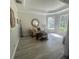 Bright sitting room boasting lots of natural light, a tray ceiling, and wood-look floors at 214 Bon Vie Pl, Valrico, FL 33594