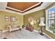 Inviting living room features wood-look floors, eclectic decor, and a tray ceiling at 214 Bon Vie Pl, Valrico, FL 33594