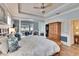 Large main bedroom showcases wood floors, tray ceiling, and plenty of natural light at 214 Bon Vie Pl, Valrico, FL 33594