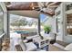 Covered patio offers ample seating, pool view, and stylish outdoor decor at 214 Bon Vie Pl, Valrico, FL 33594