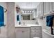 Well-maintained bathroom with white tile, modern fixtures, cabinet storage, and bright lighting in a neutral color scheme at 31 Island Way # 303, Clearwater Beach, FL 33767