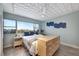 Bright bedroom with scenic views from the large windows and decorative ceiling at 31 Island Way # 303, Clearwater Beach, FL 33767