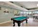Bright game room with pool table and large windows overlooking the exterior view at 31 Island Way # 303, Clearwater Beach, FL 33767