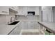 Bright kitchen featuring white cabinets, stainless steel appliances and quartz countertops at 31 Island Way # 303, Clearwater Beach, FL 33767