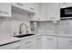 Modern kitchen showcasing quartz countertops, stainless steel appliances, and a sleek design at 31 Island Way # 303, Clearwater Beach, FL 33767