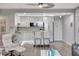 Modern kitchen features stainless steel appliances, a movable island with seating, and sleek white cabinets at 31 Island Way # 303, Clearwater Beach, FL 33767