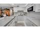Sleek white kitchen featuring quartz countertops and stainless steel appliances at 31 Island Way # 303, Clearwater Beach, FL 33767