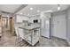 Modern kitchen with stainless steel appliances, a movable island with seating and sleek white cabinetry at 31 Island Way # 303, Clearwater Beach, FL 33767