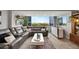 Open living room featuring a modern sectional sofa, large windows with scenic views and a colorful area rug at 31 Island Way # 303, Clearwater Beach, FL 33767