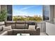 Cozy living room with comfortable gray couch, decorative pillows, and a view of the cityscape in the distance at 31 Island Way # 303, Clearwater Beach, FL 33767