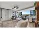 Bright living room boasts of stylish furniture, a balcony with stunning views, and modern lighting fixtures at 31 Island Way # 303, Clearwater Beach, FL 33767
