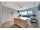 Well-lit main bedroom with a patterned ceiling, dresser, and a large window offering a picturesque city view at 31 Island Way # 303, Clearwater Beach, FL 33767