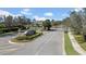 Gated community entrance with stone pillars, a decorative sign, and lush landscaping at 32202 Summerglade Dr, Wesley Chapel, FL 33545