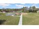 Community playground with swings, slides, and a basketball court surrounded by green grass at 32202 Summerglade Dr, Wesley Chapel, FL 33545