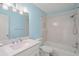 Bright bathroom features blue walls, white tile in the shower and a new vanity at 3987 Maceachen Blvd # 133, Sarasota, FL 34233