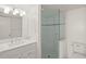 Renovated bathroom boasts glass enclosed shower, updated vanity, and bright lighting at 3987 Maceachen Blvd # 133, Sarasota, FL 34233