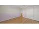 This bedroom has light hardwood floors, neutral walls, and a closet at 3987 Maceachen Blvd # 133, Sarasota, FL 34233