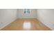Bright bedroom with wood flooring and a window letting in natural light at 3987 Maceachen Blvd # 133, Sarasota, FL 34233