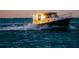 Seascape showcasing a motor yacht gliding across the water, highlighting waterfront living and recreational opportunities at 3987 Maceachen Blvd # 133, Sarasota, FL 34233
