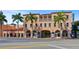 Elegant building featuring arches, palm trees, and a classic architectural style at 3987 Maceachen Blvd # 133, Sarasota, FL 34233