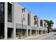 Modern building with banners and storefronts, offering interior design and art services at 3987 Maceachen Blvd # 133, Sarasota, FL 34233