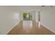 Spacious living room with hardwood floors and a sliding door to a balcony at 3987 Maceachen Blvd # 133, Sarasota, FL 34233
