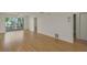 Bright living room with wood flooring and large window letting in natural light at 3987 Maceachen Blvd # 133, Sarasota, FL 34233