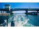 Water view from a boat, under a bridge, with clear blue water and foaming wake at 3987 Maceachen Blvd # 133, Sarasota, FL 34233