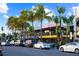 Charming street view lined with palm trees, shops, restaurants, and parked cars on a sunny day at 3987 Maceachen Blvd # 133, Sarasota, FL 34233