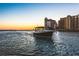 Picturesque waterfront view showcasing a boat on the water and waterfront condominium buildings in the background at 3987 Maceachen Blvd # 133, Sarasota, FL 34233