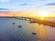 Scenic waterfront view featuring boats on the water and a picturesque sunset over the bridge at 3987 Maceachen Blvd # 133, Sarasota, FL 34233