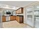 Well-lit kitchen features wood cabinets and stainless steel appliances with pool view at 4001 40Th S Way, St Petersburg, FL 33711